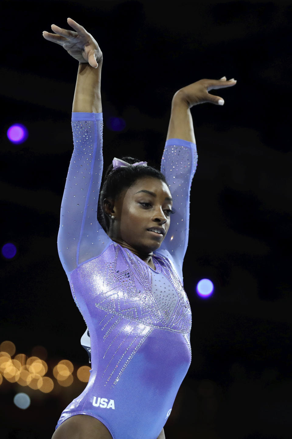 Gold medalist Simone Biles of the United States performs on the floor in the women's apparatus finals at the Gymnastics World Championships in Stuttgart, Germany, Sunday, Oct. 13, 2019. (AP Photo/Matthias Schrader)