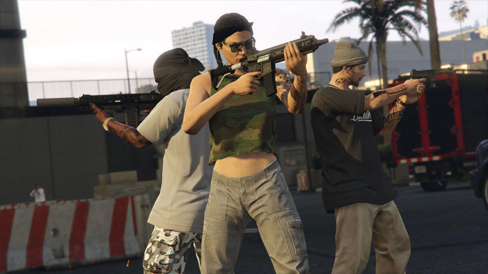 Three players standing in a triangle with guns in GTA Online