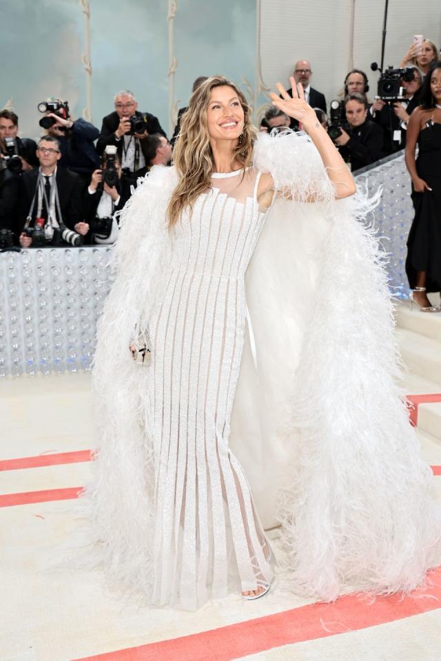 Gisele Bündchen Wears a Vintage Chanel Couture Gown With a Feathered Cape  for Her Return to the Met Gala