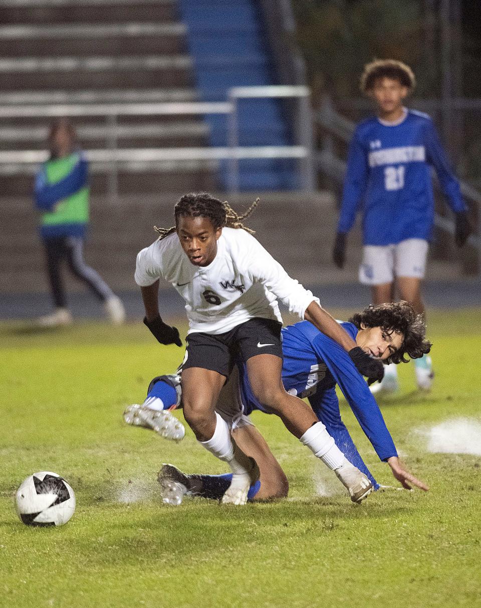 West Florida's Tyrin Joiner (No. 6) tackles Washington's Exavier Ali (No. 3) to gain possession of the ball during Tuesday's prep soccer matchup.