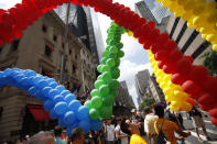 FILE- In this June 28, 2009 file photo, long strings of colorful balloons are moved to the front during New York's annual Gay Pride Parade. June 2019 Pride Month marks the 50th Anniversary of the Stonewall uprising with events that commemorate that moment and its impact through the last five decades.(AP Photo/Seth Wenig, File)