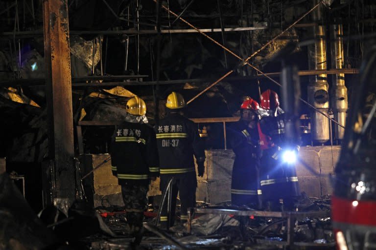 Rescuers continue their search for victims inside the Baoyuanfeng poultry plant in China's Jilin province on June 4, 2013. Survivors of an inferno at a Chinese poultry processing plant have described their desperate attempts to save others, as relatives of the 119 people killed demanded answers from authorities