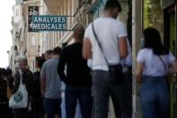 People queue to enter a laboratory to get tested for the coronavirus disease (COVID-19) in Neuilly-sur-Seine, near Paris