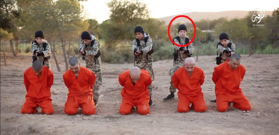 A boy believed to be Jojo Dixon, son of Sally-Anne Jones is seen (circled) in this Islamic State propaganda video before executing a Kurdish fighter.