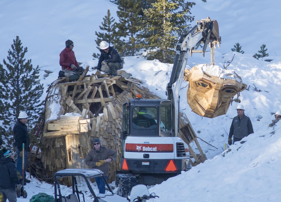 Thursday morning, Nov. 15, 2018, the Town of Breckenridge employees beheads "Isak Hearthstone," a wooden troll built by artist Thomas Dambo, by a chainsaw to remove it entirely from the Wellington Trail, in Breckenridge, Colo. The troll was created during the Breckenridge Festival of the Arts in August, but got so popular that it caused complaints from nearby homeowners due to tourists visiting, and demanded it to be removed. (Hugh Carey/Summit Daily News via AP)