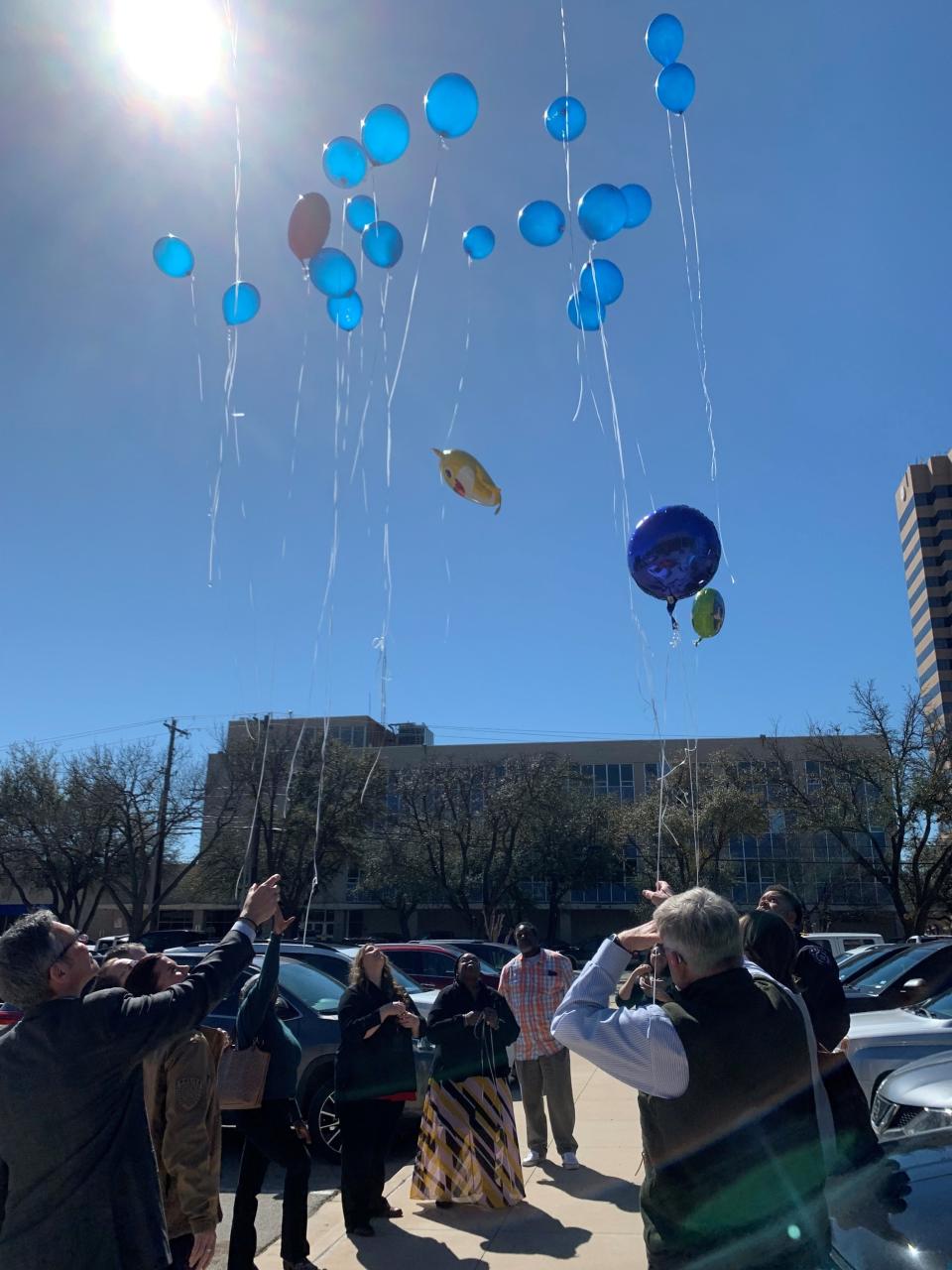 Family, investigators, attorneys and detectives stand outside the Taylor County Courthouse on Friday, March 1, for a balloon release in honor of Dairess Fuller, Jr. who died at the age of 22 months after his mother withheld nutrition and medical attention.