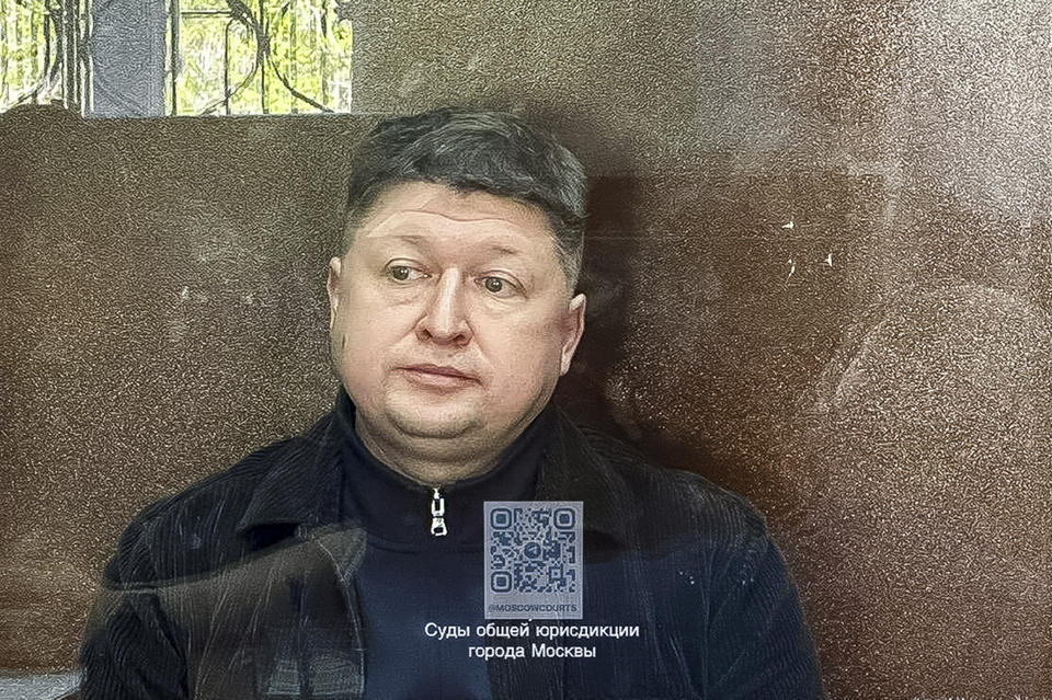 This photo taken and released by Basmanny District Court press service on Wednesday, April 24, 2024, shows Sergei Borodin sitting in a glass cage in the Basmanny District Court in Moscow, Russia. An acquaintance of Timur Ivanov, 48, one of Russia’s 12 deputy defense ministers, idenfitied as Sergei Borodin was also arrested and ordered into pre-trial detention on the same charges, court officials said in a separate statement. Both men are to remain in custody until at least June 23. (Basmanny District Court press service via AP)