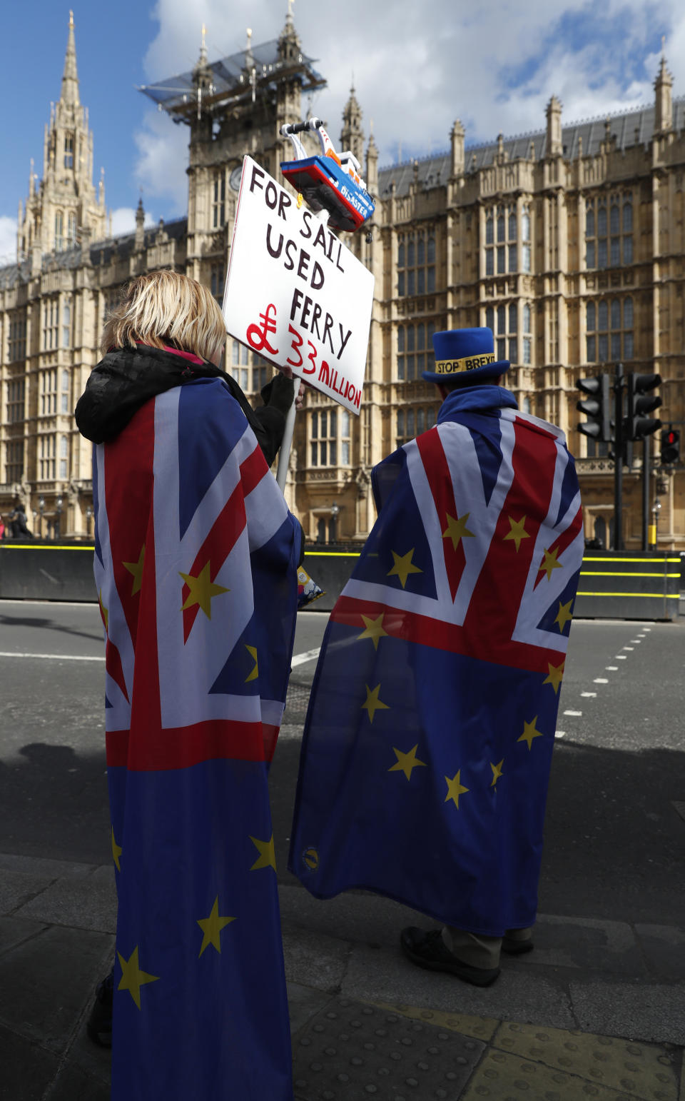 Pro-remain protester Steve Bray, right, continues his demonstration with fellow anti Brexit protesters in London, Monday, March 11, 2019. British Prime Minister Theresa May still hopes to secure changes from the EU that can win U.K. lawmakers' backing for her Brexit deal, despite a lack of progress in last-minute talks. (AP Photo/Alastair Grant)