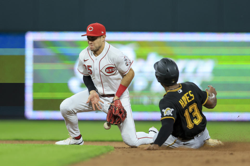 Cincinnati Reds' Alejo Lopez, left, is unable to field the ball as Pittsburgh Pirates' Ke'Bryan Hayes steals second base during the fifth inning of a baseball game in Cincinnati, Monday, Sept. 12, 2022. (AP Photo/Aaron Doster)