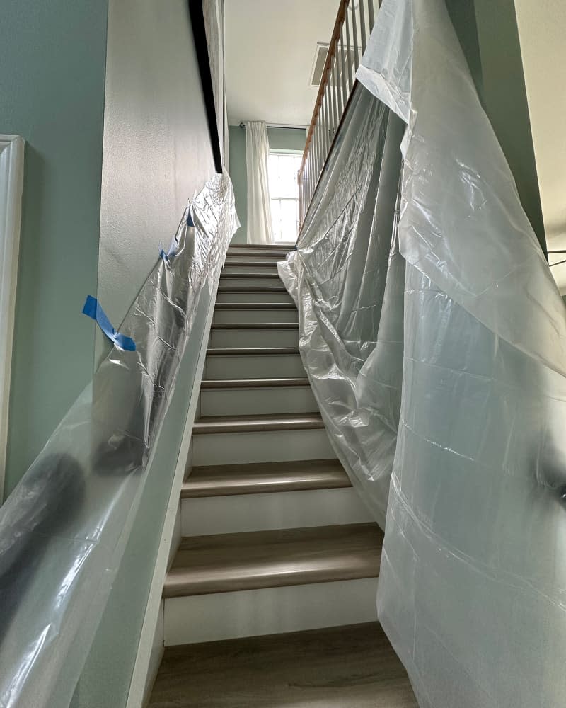 Plastic draping stairs during renovation.
