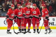 Mar 30, 2019; Raleigh, NC, USA; Carolina Hurricanes defenseman Justin Faulk (27) is congratulated by left wing Teuvo Teravainen (86) and center Sebastian Aho (20) and right wing Nino Niederreiter (21) and right wing Justin Williams (14) after scoring a third period goal against the Philadelphia Flyers at PNC Arena. Mandatory Credit: James Guillory-USA TODAY Sports