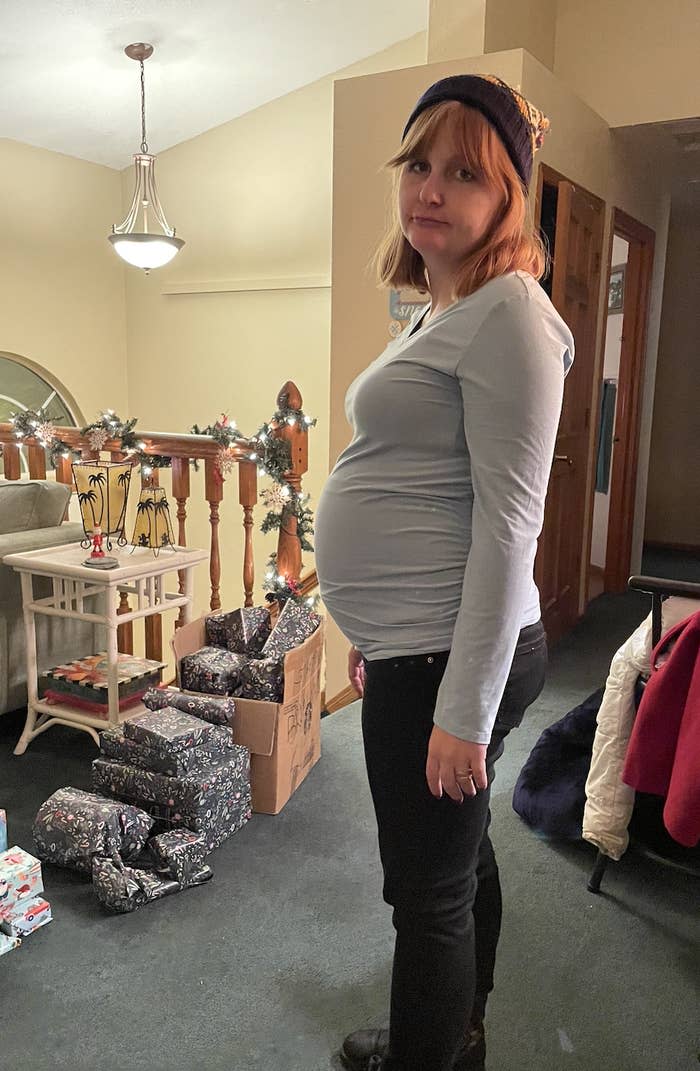 the pregnant author standing inside a house