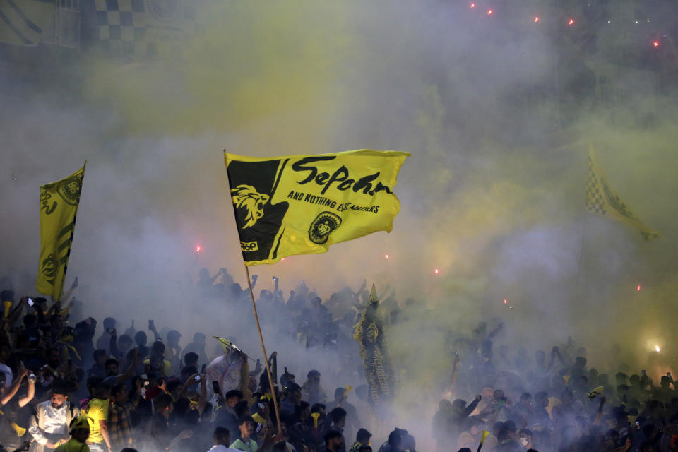 In this photo provided by Tasnim News Agency, Iranian fans burn fireworks prior to start of a soccer match between Sepahan of Iran and Saudi Arabia's Al Ittihad during AFC Champions League at Naghsh-e-Jahan stadium in the central city of Isfahan, Iran, Monday, Oct. 2, 2023. Al Ittihad refused to play the match because of the presence of a statue of slain Iranian Gen. Soleimani placed on the sideline, Saudi state media reported. (Morteza Salehi, Tasnim News Agency via AP)