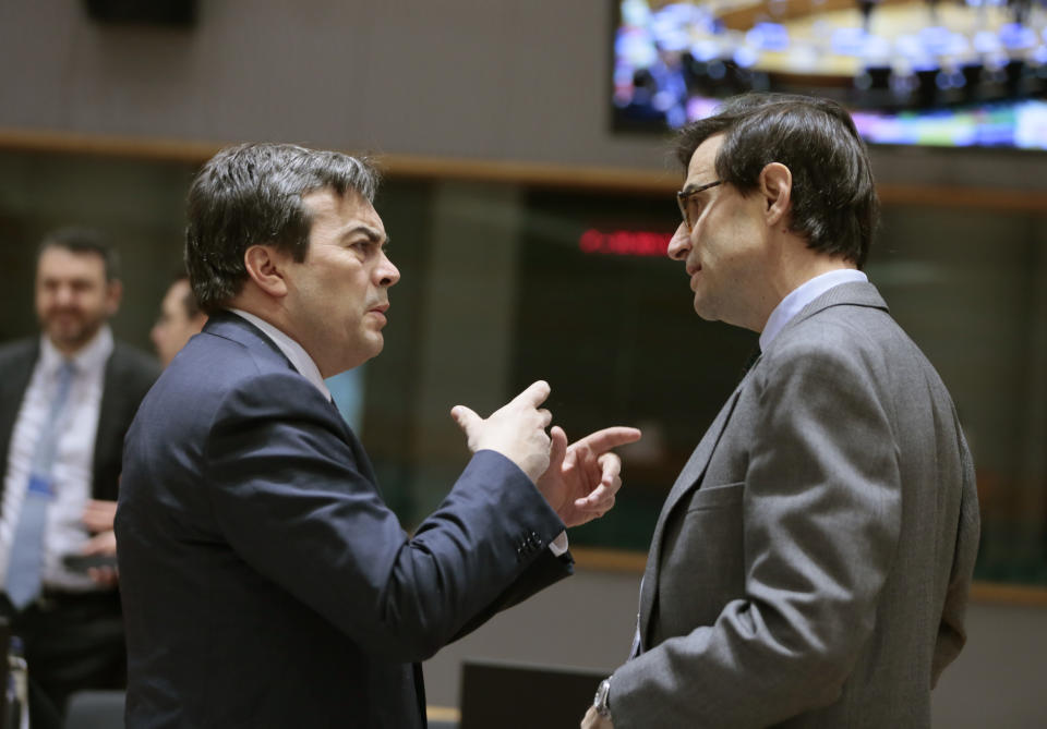 Italian Minister for European Affairs Vincenzo Amendola, left, speaks with Spain's State Secretary for EU Affairs Juan Gonzalez-Barba during a meeting of EU General Affairs ministers at the European Council building in Brussels, Tuesday, Feb. 25, 2020. European Union ministers are putting the final touches on the mandate that will be the guide for EU negotiator Michel Barnier as he sits own with UK officials to thrash out a free trade deal over the next ten months. (AP Photo/Virginia Mayo)