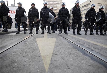 Police stand in their positions as they face anti-government protesters in Sarajevo February 6, 2014. REUTERS/Dado Ruvic