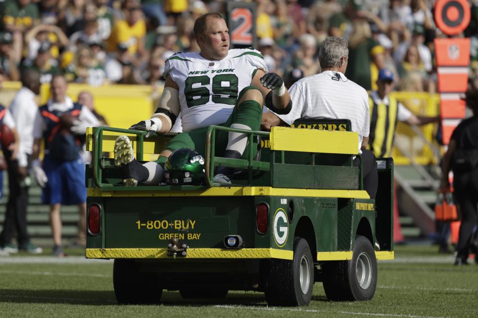New York Jets' Conor McDermott is taken off the field on a cart after being injured during the first half of a preseason NFL football game against the New York Jets Saturday, Aug. 21, 2021, in Green Bay, Wis. (AP Photo/Mike Roemer)