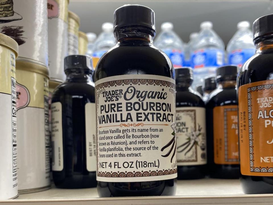 Black and white bottle of bourbon vanilla extract on shelf at Trader Joe's