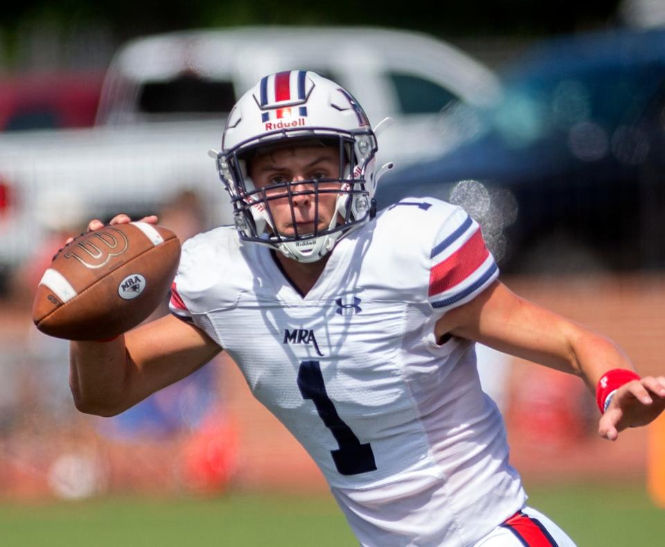 Madison-Ridgeland Academy quarterback John White looks for an opening during play against the Oakland, Tenn., Patriots at MRA in Madison Saturday, Aug. 28, 2021.