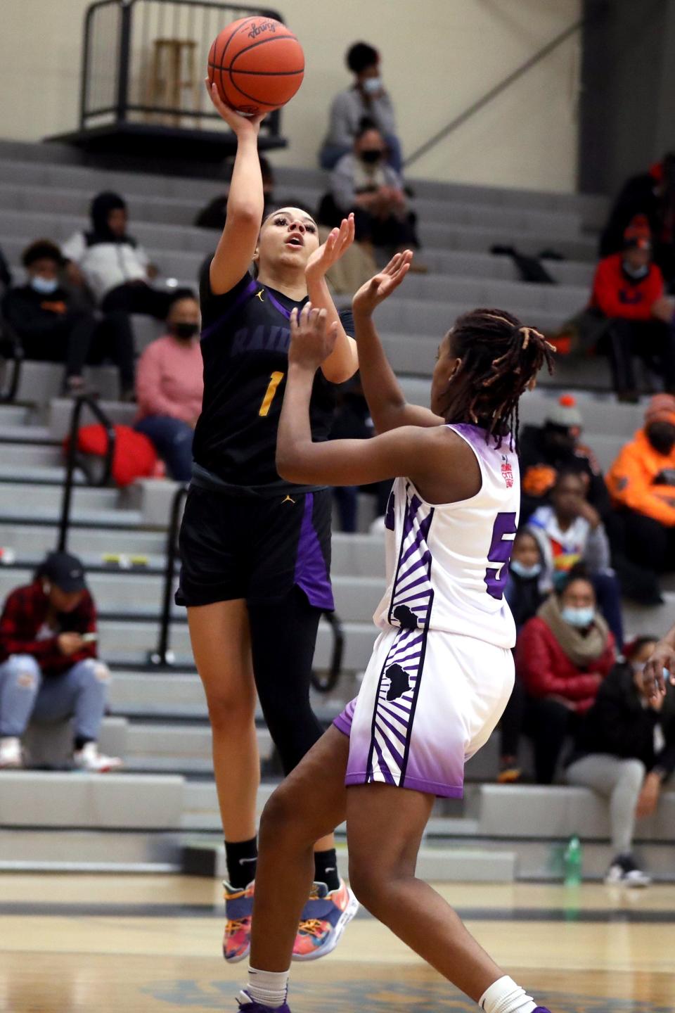 Reynoldsburg's Mya Perry puts up a shot over Africentric's Samairah Thompson during the Nubian Classic on Jan. 22. The Raiders beat the host Nubians 74-50 to improve to 14-2.