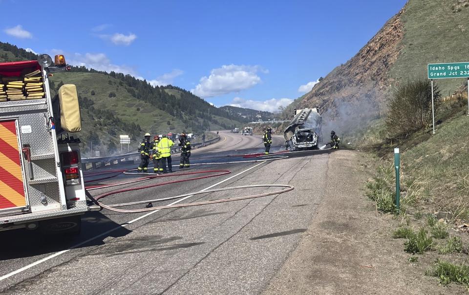 This image provided by the Jefferson County Sheriff's Office shows firefighters at the scene of a tanker truck fire after a crash on Colorado's main east-west highway near Denver on Thursday, May 16, 2024. (Jefferson County Sheriff's Office via AP)