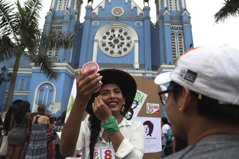 En esta foto del 20 de enero de 2020, Gahela Cari, que se postula para el Congreso, retoca su maquillaje mientras hace campaña en Lima, Perú. La mujer transgénero de origen indígena se presenta en las elecciones legislativas del domingo. (AP Foto / Martín Mejía)