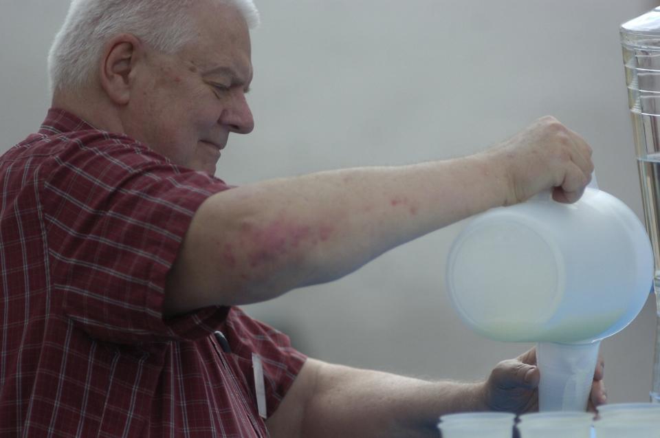 Volunteer Jim Dalenburgh pours lemonade Sunday afternoon during the Ashland County Historical Society Ice Cream Social.