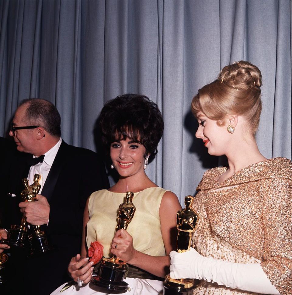 <p>Elizabeth Taylor in the center won her first Academy Award for Best Actress for a role she disliked, a call girl in the drama <em>BUtterfield 8</em>, which was also her last film for the studio MGM. The other winners here are Burt Lancaster and Shirley Jones who both won for their performances in the film <em>Elmer Gantry</em>. </p>