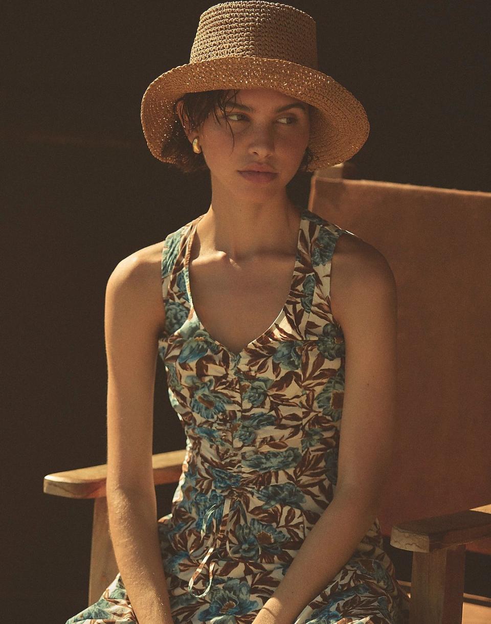 model wearing straw bucket hat with floral matching set