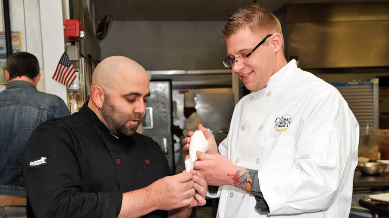 Duff Goldman works with another chef