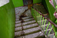 Blood stains mark a stairwell inside a building damaged in an overnight missile strike in Sloviansk, Ukraine, Tuesday, May 31, 2022. (AP Photo/Francisco Seco)