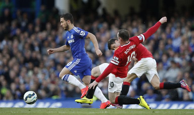 Chelsea's Belgian midfielder Eden Hazard (L) skips past a challenge from Manchester United's English striker Wayne Rooney (R) during the English Premier League football match in London on April 18, 2015