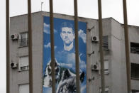 A billboard depicting Serbian tennis player Novak Djokovic hangs on a building in Belgrade, Serbia, Thursday, Jan. 6, 2022. The Australian government has denied No. 1-ranked Djokovic entry to defend his title in the year's first tennis major and canceled his visa because he failed to meet the requirements for an exemption to the country's COVID-19 vaccination rules. (AP Photo/Darko Vojinovic)