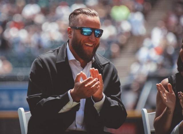 Former Chicago White Sox pitcher Mark Buehrle, center, watches with his  daughter Brooklyn, right, and son Braden, as his No. 56, top right, is  retired during ceremonies before a baseball game between