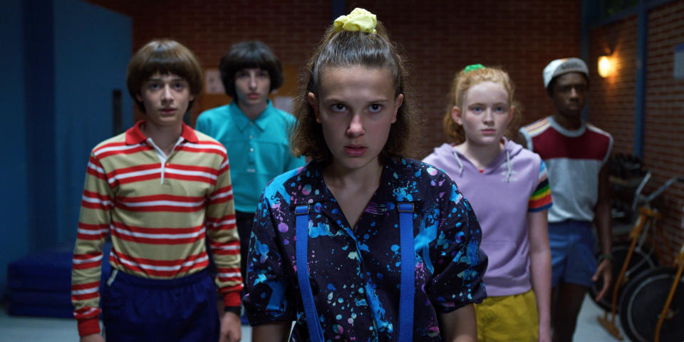 eleven standing in front of the group of the rest of the kids