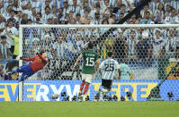 Mexico's goalkeeper Guillermo Ochoa fails to save the second goal for Argentina during the World Cup group C soccer match between Argentina and Mexico, at the Lusail Stadium in Lusail, Qatar, Saturday, Nov. 26, 2022. (AP Photo/Hassan Ammar)