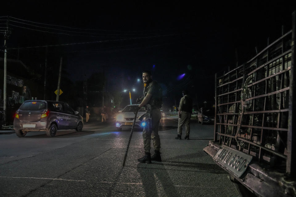 Indian policeman guard on a road ahead of G20 tourism working group meeting in Srinagar, Indian controlled Kashmir, Monday, May 15, 2023. Indian authorities have stepped up security and deployed elite commandos to prevent rebel attacks during the meeting of officials from the Group of 20 industrialized and developing nations in the disputed region next week. (AP Photo/Mukhtar Khan)