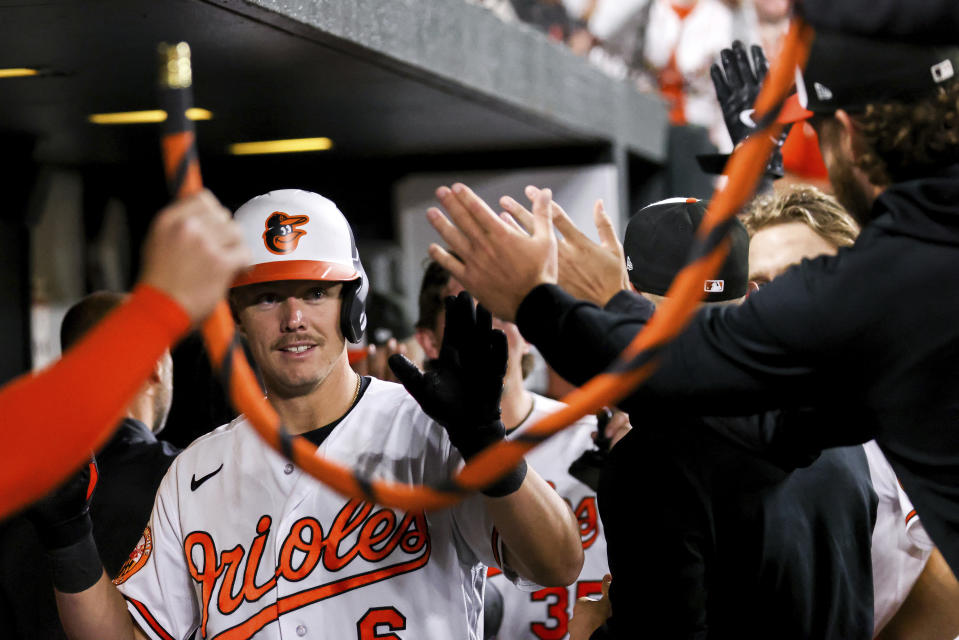 Baltimore Orioles first baseman Ryan Mountcastle (6) high fives teammates in the dugout after hitting a home run during the fifth inning of a baseball game against the Oakland Athletics, Tuesday, April 11, 2023, in Baltimore. (AP Photo/Julia Nikhinson)