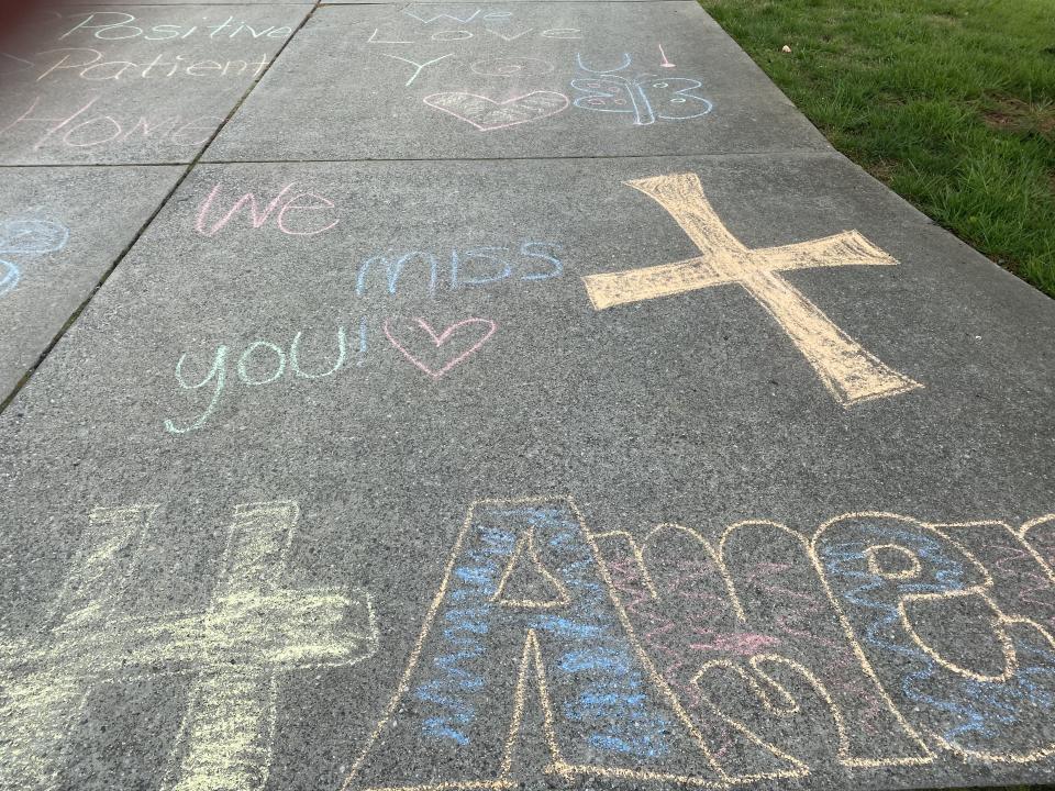 The sidewalk was decorated with inspirational chalk messages for residents and their loved ones. (Photo: Jenny Brinkle)