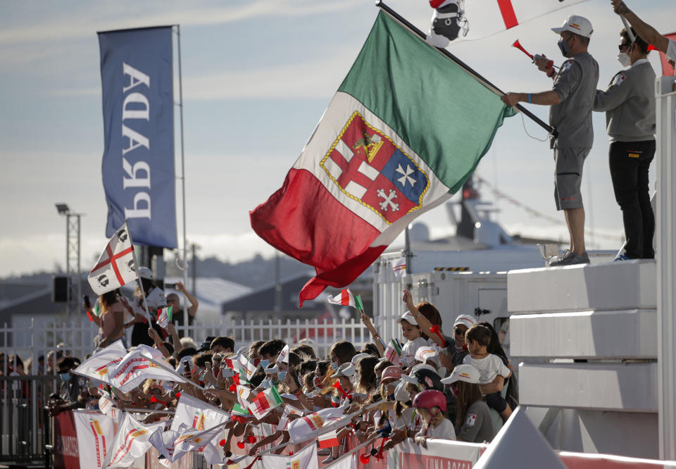 Supporters of Italy's Luna Rossa team join in the celebration after defeating Britain's INEOS Team UK in race eight of the Prada Cup on Auckland's Waitemata Harbour, New Zealand, Sunday, Feb.21, 2021.Italian challenger Luna Rossa Prada Pirelli will race defender Emirates Team New Zealand in the 36th match for the America's Cup after beating Britain's Ineos Team UK in two races Sunday to seal a 7-1 win in the best-of-13 race challengers series final. (Alex Burton/NZ Herald via AP)