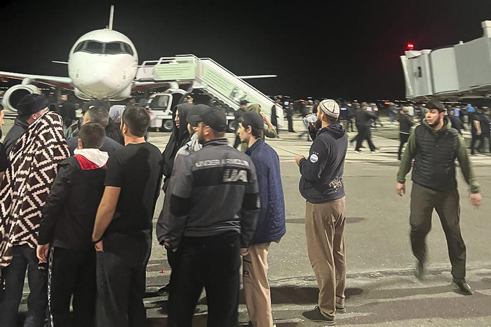 FILE - People in the crowd walk shouting antisemitic slogans at an airfield of the airport in Makhachkala, Russia, on Oct. 30, 2023. Antisemitism is spiking across Europe after Hamas' Oct. 7 massacre and Israel's bombardment of Gaza, worrying Jews from London to Geneva and Berlin. (AP Photo, File)