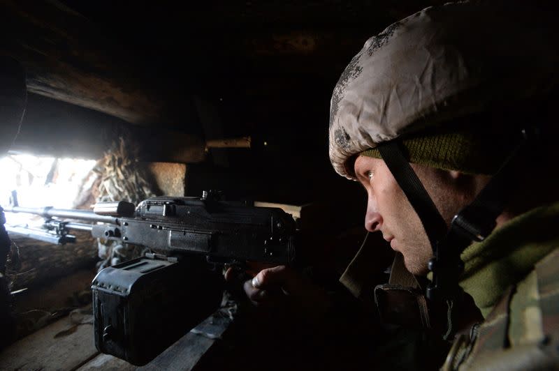 A serviceman is seen at a position on the front line near the village of Zolote