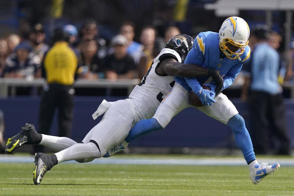 Los Angeles Chargers wide receiver DeAndre Carter, right, is tackled by Jacksonville Jaguars linebacker Devin Lloyd during the second half of an NFL football game in Inglewood, Calif., Sunday, Sept. 25, 2022. (AP Photo/Mark J. Terrill)