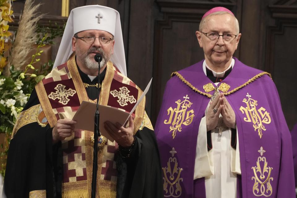 The head of Poland's Roman Catholic Church, Archbp Stanislaw Gadecki, right, and Archbishop Sviatoslav Shevchuk, left, of the Ukrainian Greek Catholic Church hold a reconciliation religious service as part of observances honoring some 100,000 Poles murdered by Ukrainian nationalists in 1943-44, at St. John's cathedral in Warsaw, Poland, on Friday, July 7, 2023. (AP Photo/Czarek Sokolowski)