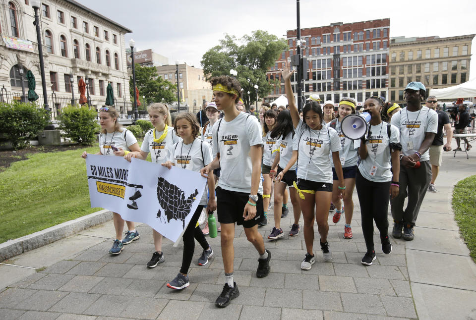 Griffin Gould, 16, an Arlington, Mass., high school student, center, walks with others as they depart Worcester Common, in Worcester, Mass., at the start of a planned 50-mile march, Thursday, Aug. 23, 2018. The march, held to call for gun law reforms, began Thursday, in Worcester, and is scheduled to end Sunday, Aug. 26, 2018, in Springfield, Mass., at the headquarters of gun manufacturer Smith & Wesson. (AP Photo/Steven Senne)