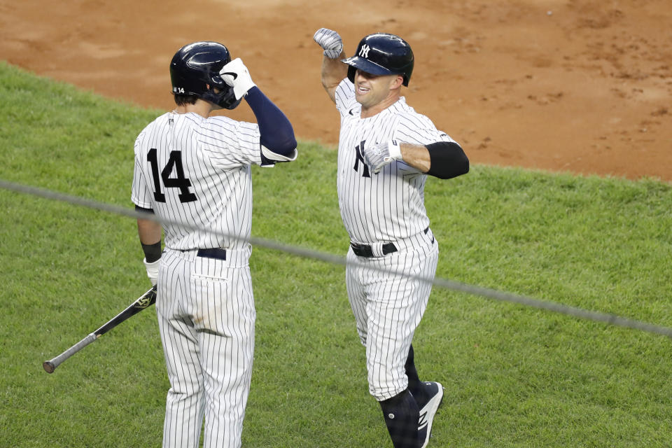 New York Yankees Brett Gardner, right, celebrates with the Yankees Tyler Wade (14) after hitting a solo home run during the third inning of a baseball game against the Philadelphia Phillies, Monday, Aug. 3, 2020, at Yankee Stadium in New York. (AP Photo/Kathy Willens)