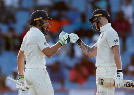 FILE PHOTO: Cricket - West Indies v England - Third Test - Darren Sammy National Cricket Stadium, St Lucia - February 9, 2019 England's Jos Buttler celebrates a half century with Ben Stokes Action Images via Reuters/Paul Childs/File Photo