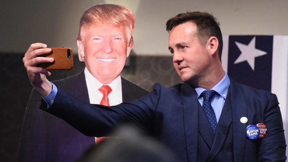 A man takes a selfie with a Donald Trump cutout at an event hosted by the US Embassy at the National Press Club in Canberra. Photo: AAP