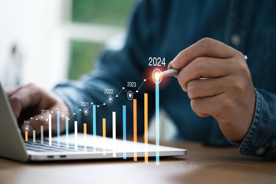 2024 growth concept chart next to laptop.