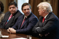 FILE - Governor-elect Ron DeSantis, R-Fla., talks with President Donald Trump during a meeting with newly elected governors in the Cabinet Room of the White House, Dec. 13, 2018, in Washington. From left, Governor-elect J.B. Pritzker, D-Ill., DeSantis, and Trump. (AP Photo/Evan Vucci, File)
