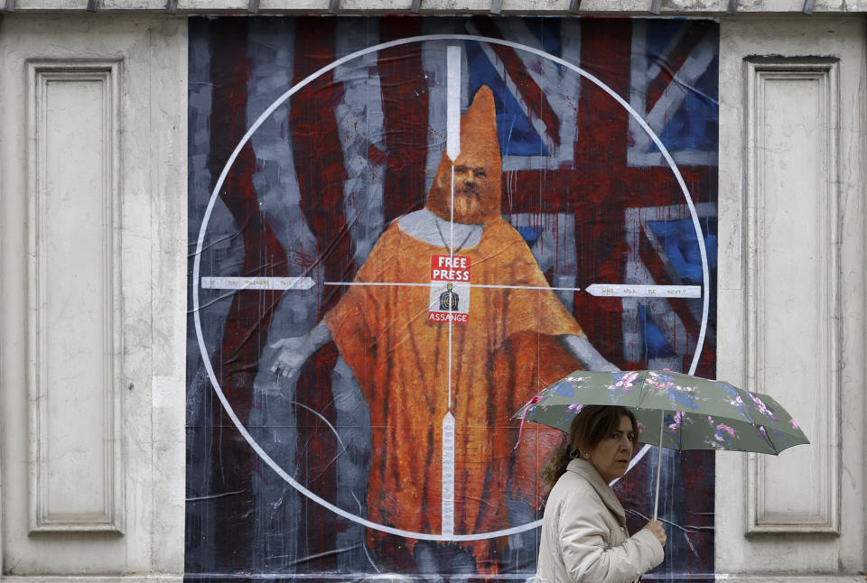 A pedestrian passes street art depicting Julian Assange near Westminster Magistrates' Court in London where Assange is expected to appear as he fights extradition to the United States on charges of conspiring to hack into a Pentagon computer, in London, Monday Oct. 21, 2019. U.S. authorities accuse Assange of scheming with former Army intelligence analyst Chelsea Manning to break a password for a classified government computer. (AP Photo/Kirsty Wigglesworth)
